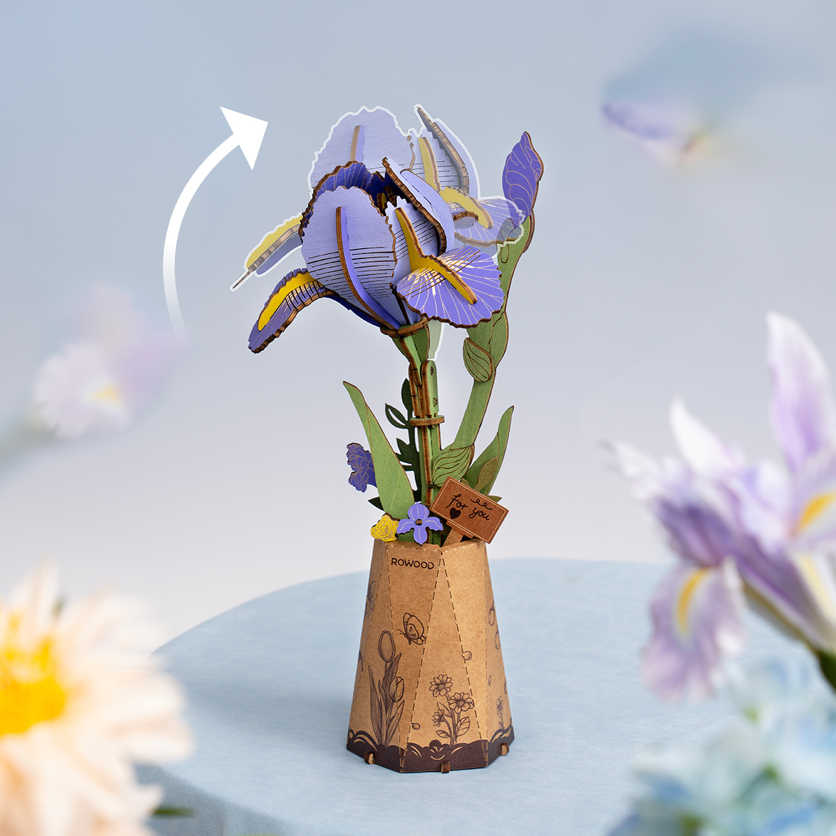 Purple Iris TW121 assembly scene with hands arranging the wooden flower