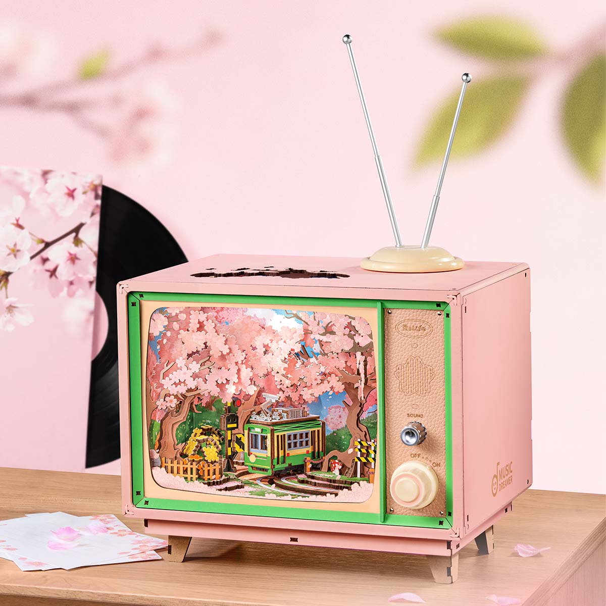 Rolife Sakura Dreamy Tour AMT02 music box television in a pink tabletop scene