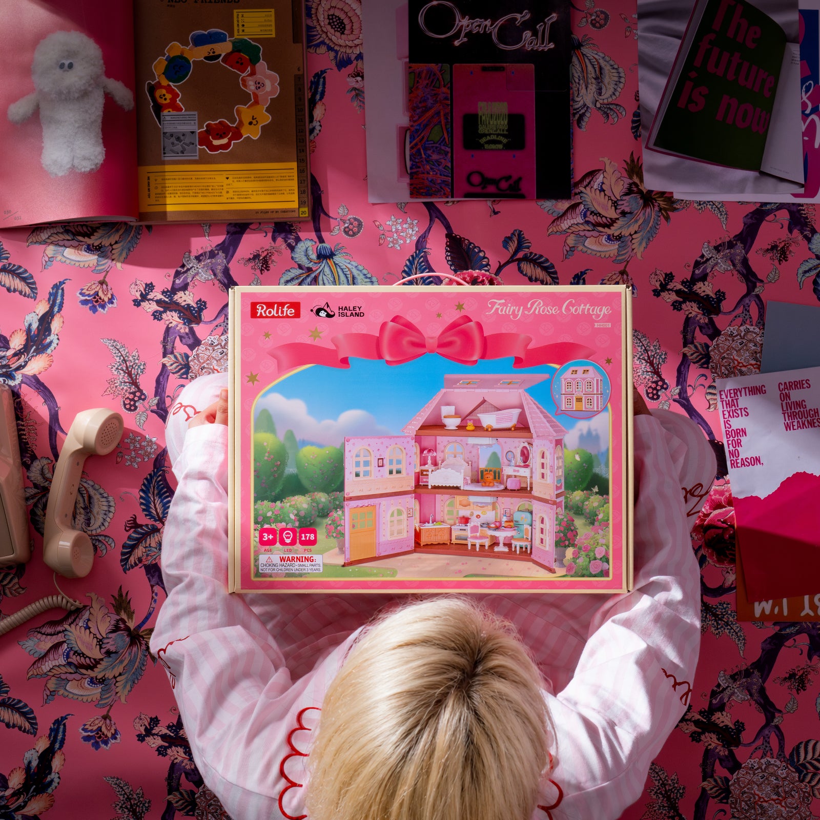 Rolife Fairy Rose Cottage HH001 DIY kit packaging shown in a pink room scene.