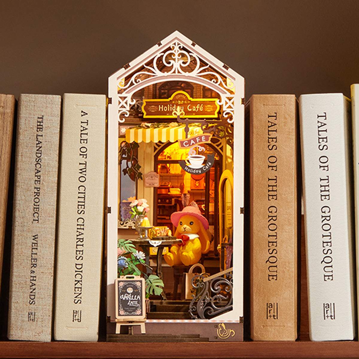 Holiday Cafe TGB15 shelf display between books with warm interior lighting