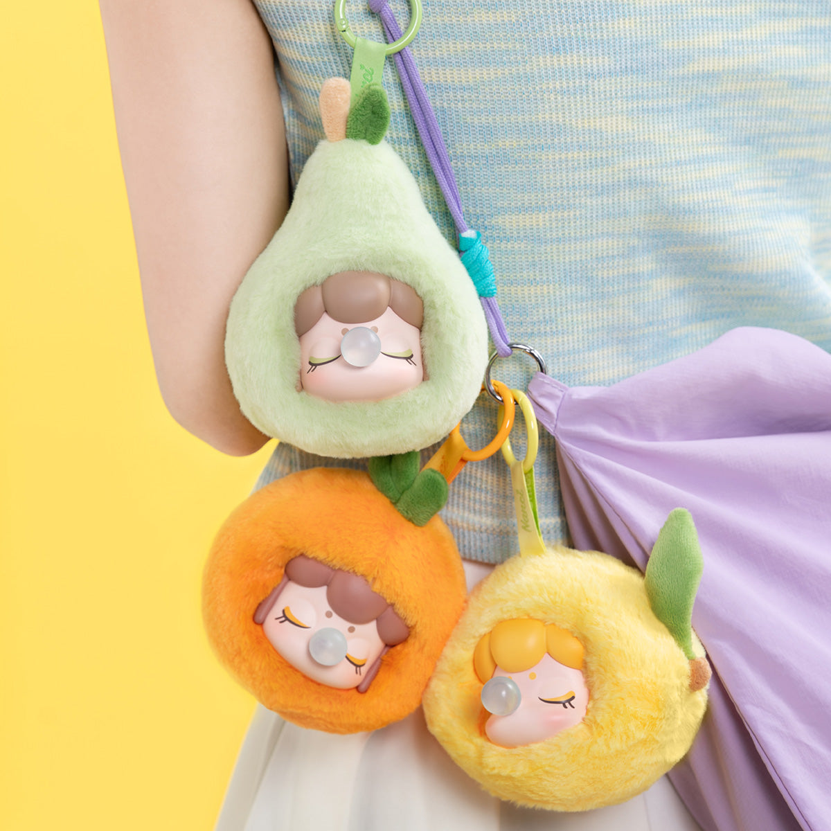 Nanci Fruit Mood plush pendants hanging together as bag charms