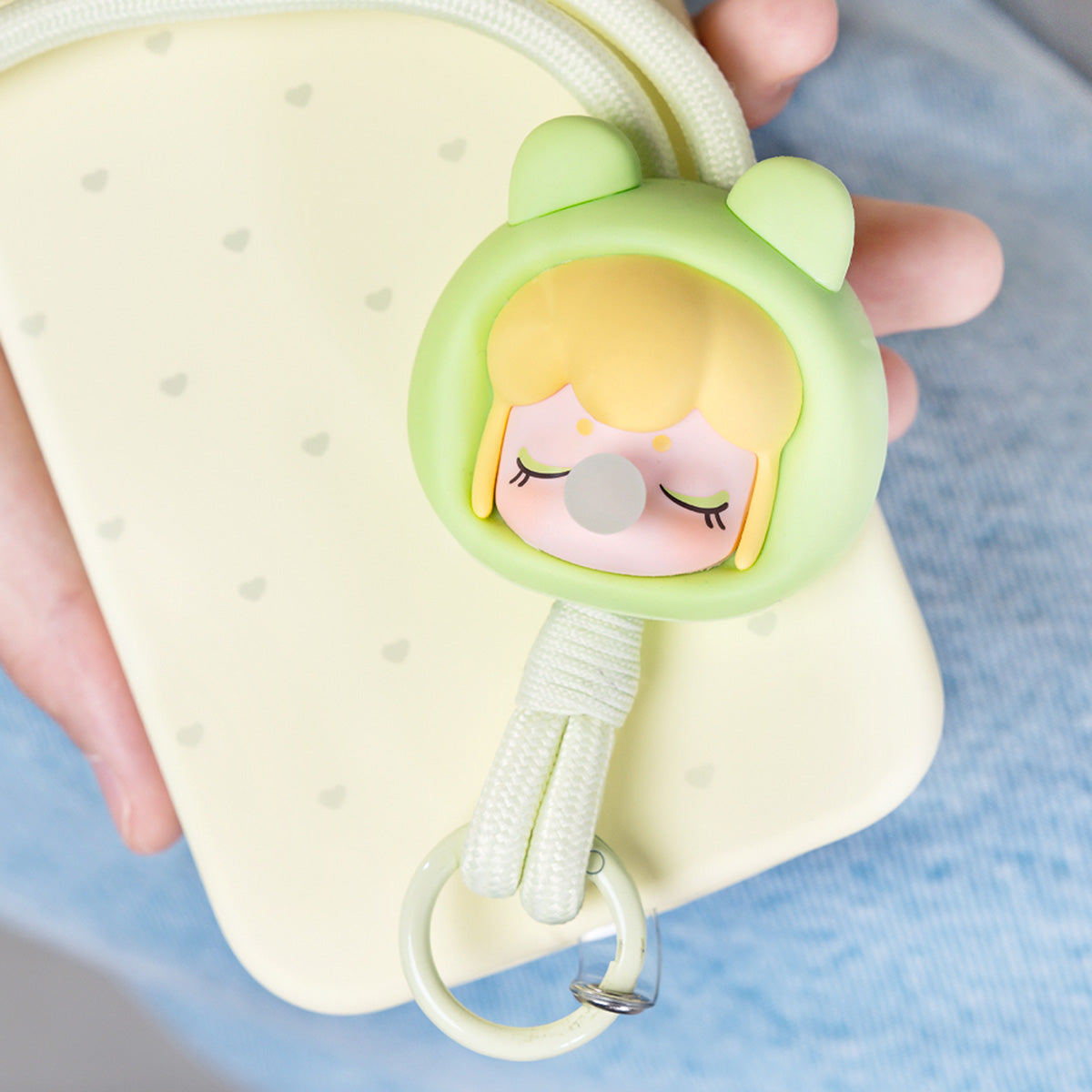 Baby Nanci Fluffy Party avocado phone chain attached to a smartphone