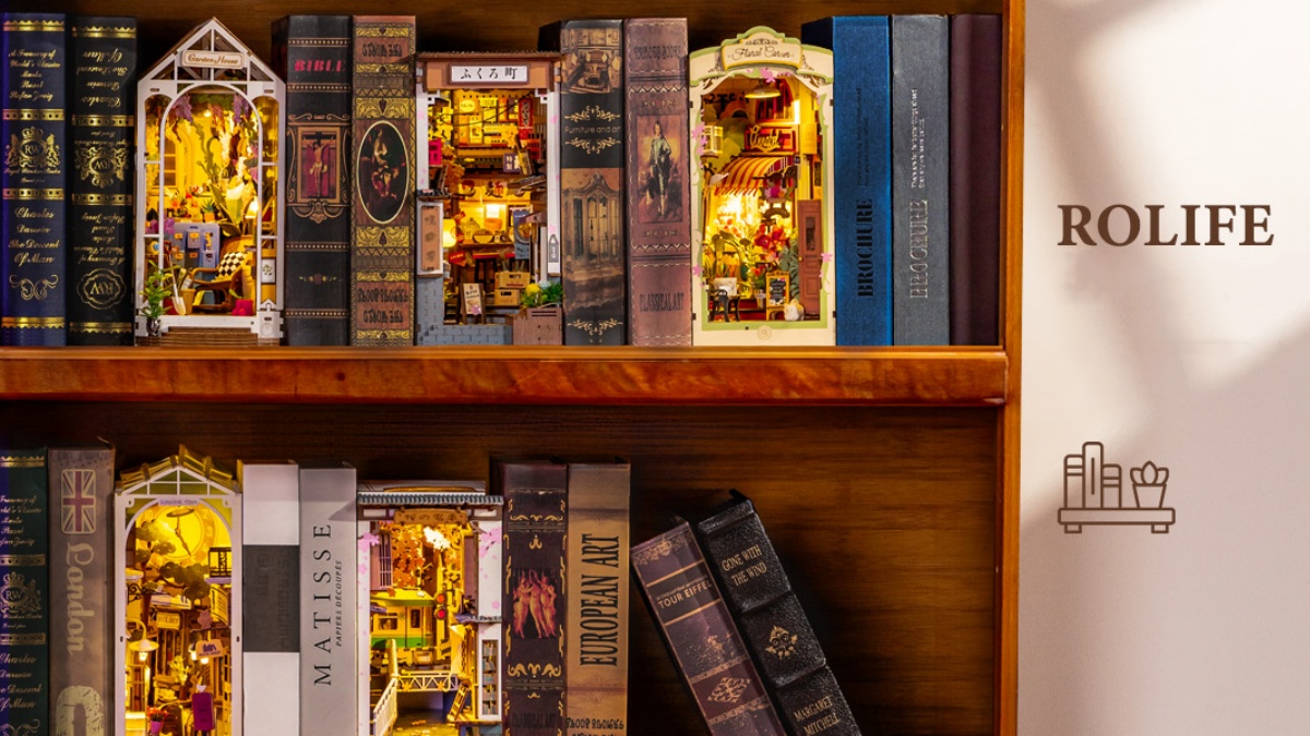 Rolife book nook kits displayed between books on a wooden bookshelf