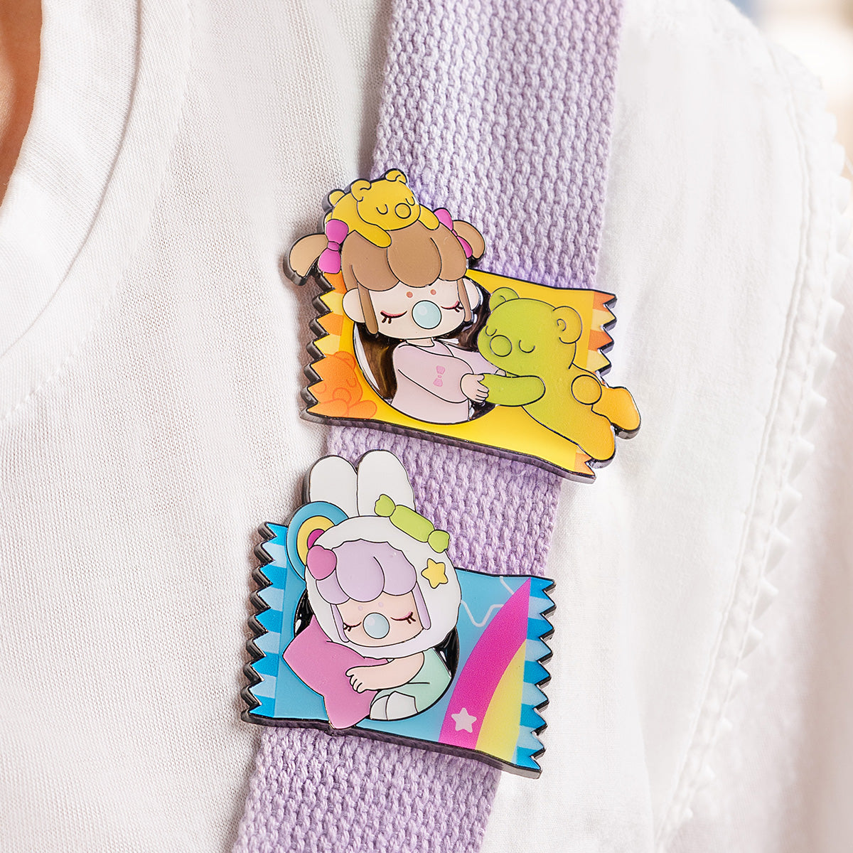 Nanci Sweet Time badges clipped to a bag strap