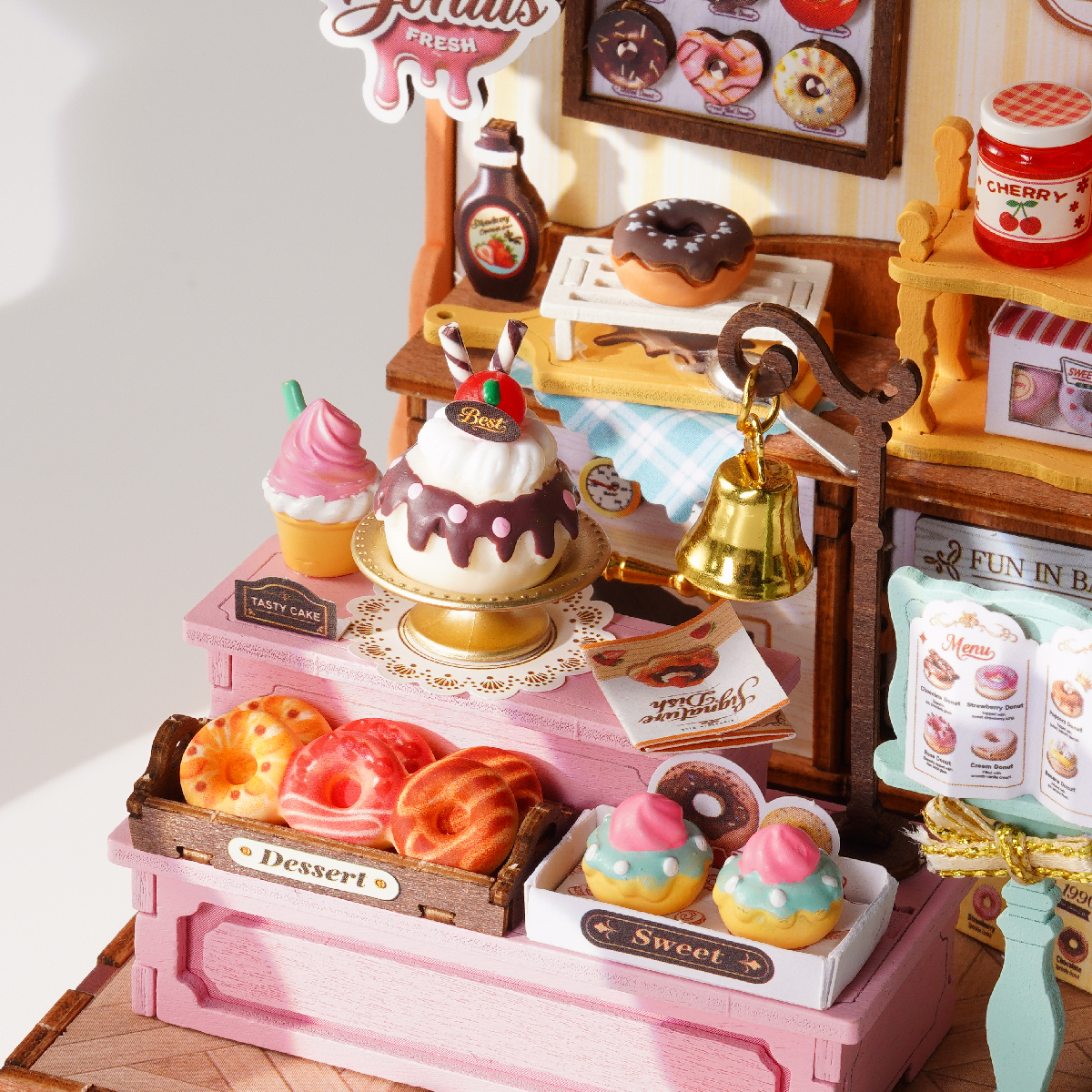 Sweetie's Donut Shop dessert counter with cake, croissants, donuts, and serving accessories