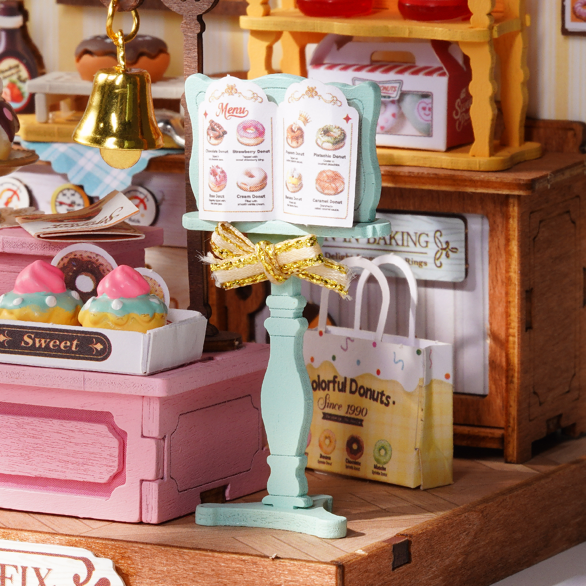 Close-up of Sweetie's Donut Shop oven, menu stand, drinks, and bakery shelves
