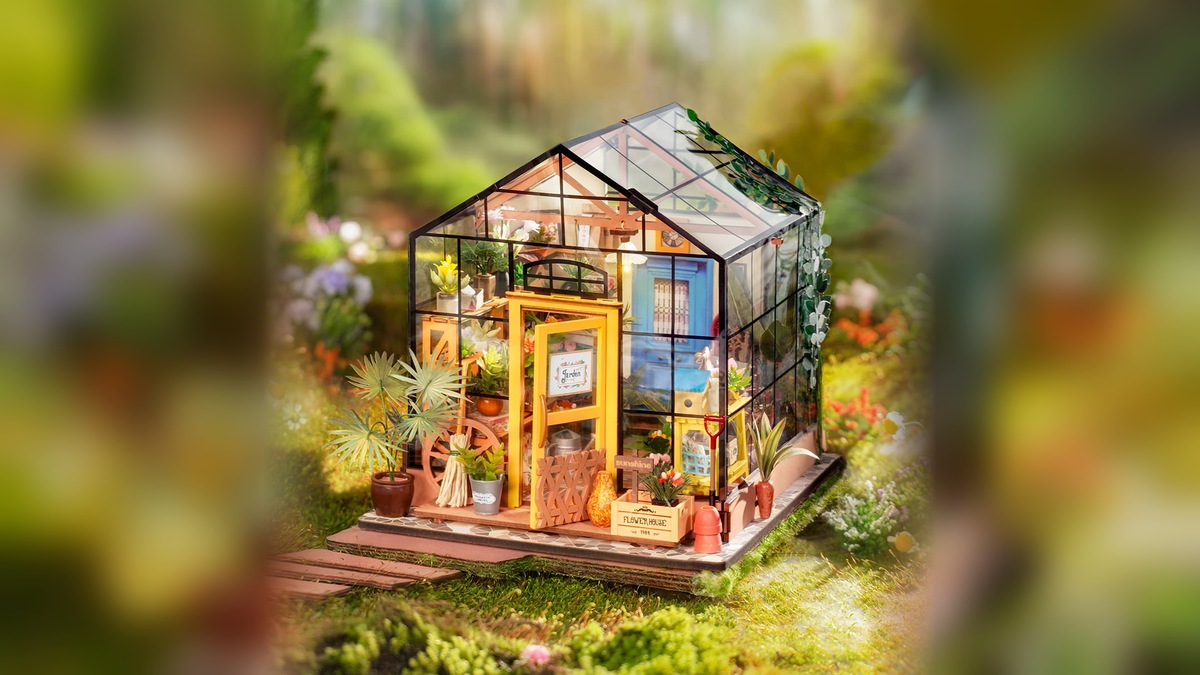 Rolife Cathy's Flower House DG104 transparent miniature greenhouse in a garden setting