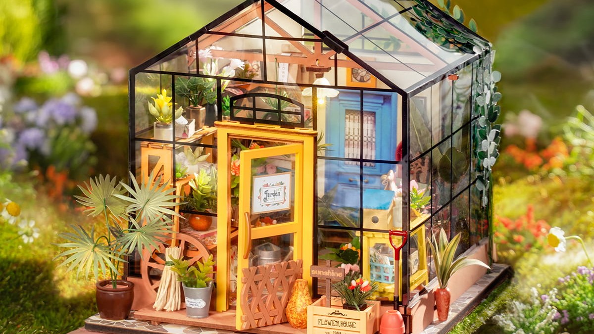 Rolife Cathy's Flower House in a garden setting for a DIY miniature kit buying guide