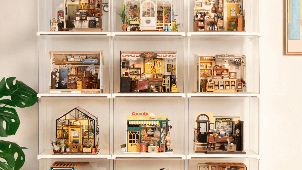 Rolife miniature houses protected in clear display boxes on a shelf