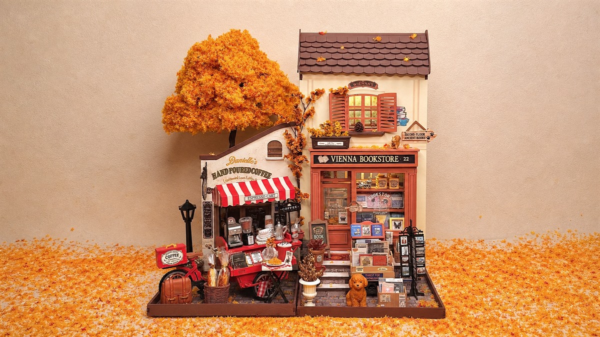 Cozy Rolife autumn miniature display featuring Vienna Bookstore DG183 and a coffee cart under an orange fall tree.