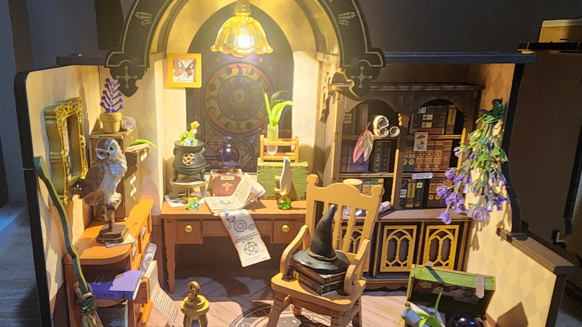 The Magic Study DG166 illuminated build by Rolife Community maker Pola, showing the stained-glass window, spell books, and study furniture